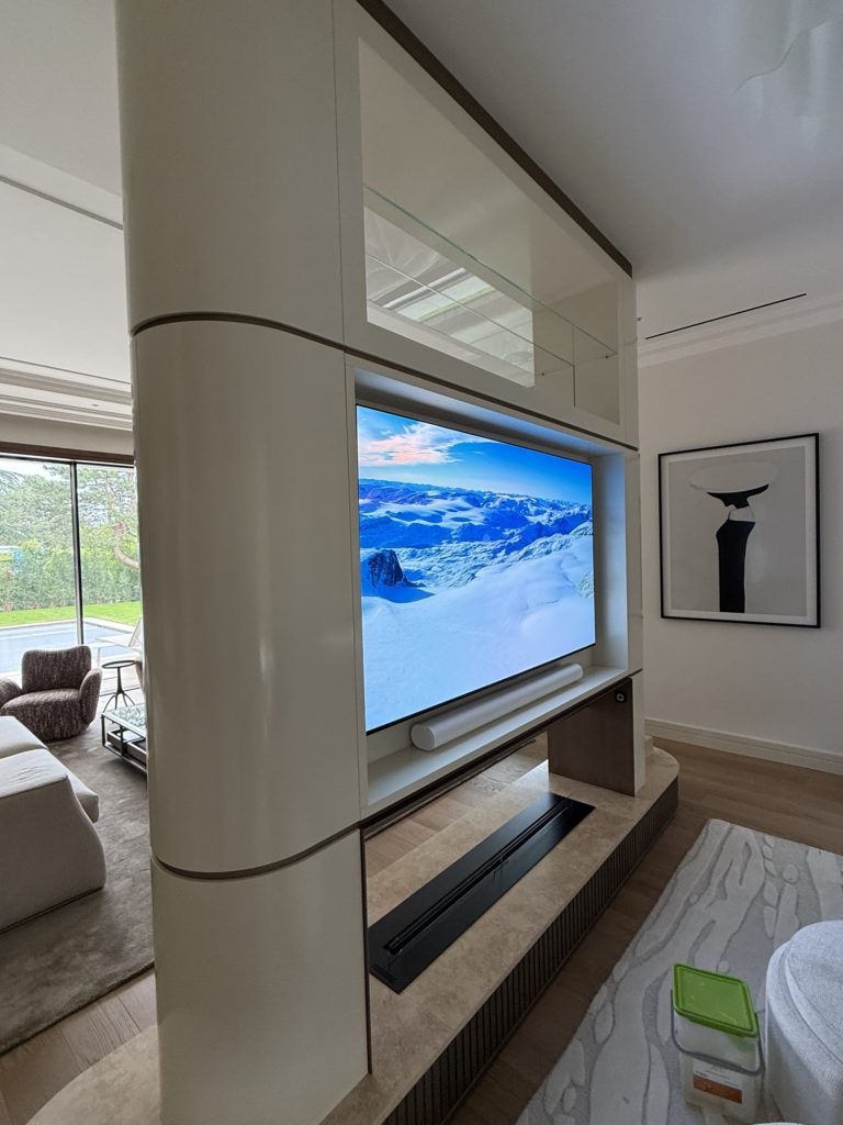 Cloison TV double face entre salon et TV room, villa privée à Genève
