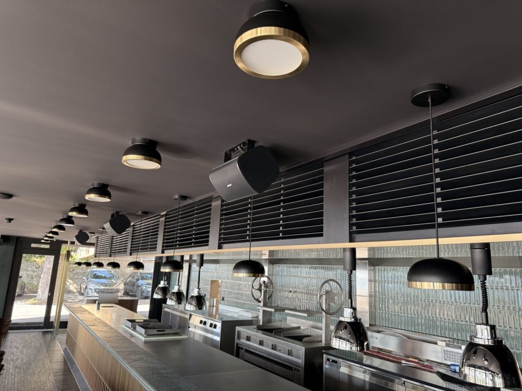 Cuisine ouverte avec plafonniers laiton et enceintes Bose